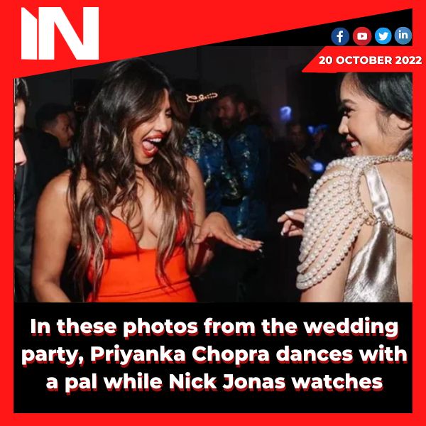 In these photos from the wedding party, Priyanka Chopra dances with a pal while Nick Jonas watches.