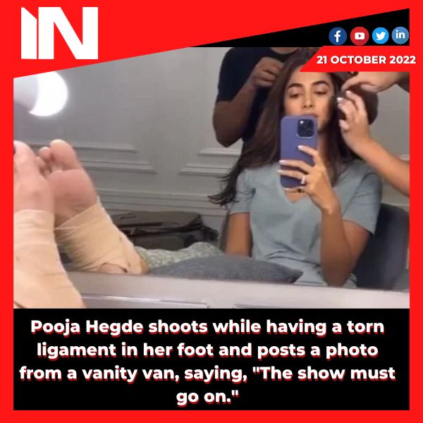 Pooja Hegde shoots while having a torn ligament in her foot and posts a photo from a vanity van, saying, “The show must go on.”